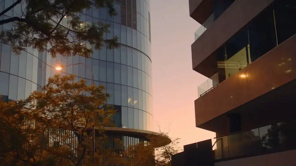 Contemporary office buildings with glass facades at sunset in Australia.
